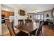 Elegant dining area with hardwood floors, a view of the living room and an adjacent kitchen at 1300 Kennedy Dr, Northglenn, CO 80234