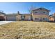 Charming two-story home featuring a manicured lawn and a classic brick facade at 1300 Kennedy Dr, Northglenn, CO 80234