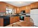 Bright kitchen with wooden cabinets, black appliances, and a view to the outside at 1300 Kennedy Dr, Northglenn, CO 80234