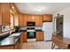 Functional kitchen featuring wooden cabinetry, modern appliances, and a bright, airy atmosphere at 1300 Kennedy Dr, Northglenn, CO 80234