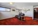 Carpeted living room with a leather couch, pictures on the wall, and natural light from windows at 1300 Kennedy Dr, Northglenn, CO 80234