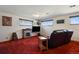 Finished basement featuring carpet, a fireplace, flat screen, and leather reclining couch at 1300 Kennedy Dr, Northglenn, CO 80234