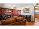 Cozy living room and dining area with hardwood floors, fireplace, and adjacent kitchen view at 1300 Kennedy Dr, Northglenn, CO 80234