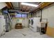 Finished basement laundry area with washer, dryer, and utility sink at 5222 S Emporia Way, Greenwood Village, CO 80111