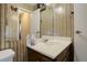 Small bathroom with dark wood vanity and striped wallpaper at 5222 S Emporia Way, Greenwood Village, CO 80111