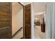 View from hallway into bedroom with wooden door at 5222 S Emporia Way, Greenwood Village, CO 80111