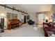 Living room with vaulted ceilings, comfy seating, and a piano at 5222 S Emporia Way, Greenwood Village, CO 80111