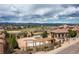 Aerial view of the community pool, clubhouse, and sprawling green spaces with mountain views at 9450 Sori Ln, Highlands Ranch, CO 80126