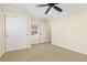 Neutral bedroom features a ceiling fan, plush carpet, closet and bright natural light at 9450 Sori Ln, Highlands Ranch, CO 80126