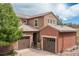 Beautiful two-story home featuring a three-car garage and stucco exterior with stone accents adding curb appeal to this property at 9450 Sori Ln, Highlands Ranch, CO 80126