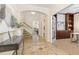 Inviting foyer boasts decorative tile flooring, arched doorway, and elegant staircase, offering a warm welcome into the home at 9450 Sori Ln, Highlands Ranch, CO 80126