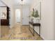 Charming foyer with decorative tiled floor, modern console table, and an open archway creating a light and airy entrance at 9450 Sori Ln, Highlands Ranch, CO 80126