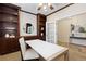 Spacious home office features custom built-in shelving and cabinets, modern desk space, and adjacent foyer entrance at 9450 Sori Ln, Highlands Ranch, CO 80126