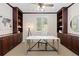 Well-appointed home office with built-in cabinetry, a bright window, and a modern desk creating an ideal workspace at 9450 Sori Ln, Highlands Ranch, CO 80126