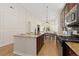 Gourmet kitchen with an expansive island, modern appliances, and seamless access to a bright and inviting living area at 9450 Sori Ln, Highlands Ranch, CO 80126