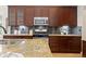 Gourmet kitchen features granite countertops, stainless steel appliances, and custom cabinetry providing a stylish space at 9450 Sori Ln, Highlands Ranch, CO 80126