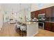Open-concept kitchen with a large island, stainless steel appliances, and seamless flow into the inviting living area at 9450 Sori Ln, Highlands Ranch, CO 80126