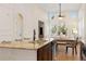 Stunning kitchen boasts a center island, sleek appliances, and seamless integration with the adjacent dining and living areas at 9450 Sori Ln, Highlands Ranch, CO 80126