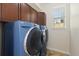 A laundry room features front load washer and dryer and built-in cabinets at 9450 Sori Ln, Highlands Ranch, CO 80126