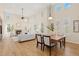 Bright and airy living room with high ceilings, large windows, fireplace, and open dining area at 9450 Sori Ln, Highlands Ranch, CO 80126
