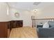 A well-lit loft features wood floors, an accent chair, and a built-in cabinet at 9450 Sori Ln, Highlands Ranch, CO 80126