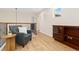 A well-lit loft features wood floors, an accent chair, and a built-in cabinet at 9450 Sori Ln, Highlands Ranch, CO 80126