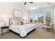 Comfortable main bedroom with vaulted ceiling, large windows, and a cozy seating area at 9450 Sori Ln, Highlands Ranch, CO 80126