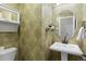 Charming powder room with decorative wallpaper, pedestal sink, and round mirror at 9450 Sori Ln, Highlands Ranch, CO 80126