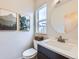 Bright powder room boasts a vanity, toilet, and decorative wall art at 1558 White Violet Way, Louisville, CO 80027