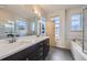 Bathroom boasts double vanities, a soaking tub, and a glass-enclosed shower at 1558 White Violet Way, Louisville, CO 80027