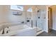Bathroom features a sleek bathtub with an adjacent glass-enclosed shower at 1558 White Violet Way, Louisville, CO 80027