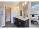 Bathroom features double sinks, a large mirror, and sleek, modern fixtures at 1558 White Violet Way, Louisville, CO 80027