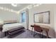Bedroom featuring a decorative mirror, vanity, bench and overhead string lights at 1558 White Violet Way, Louisville, CO 80027