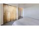 Bedroom featuring light wood closet with modern doors and neutral walls with light grey carpet at 1558 White Violet Way, Louisville, CO 80027