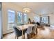 Dining area with hardwood floors, modern light fixture, and multiple windows providing an abundance of natural light at 1558 White Violet Way, Louisville, CO 80027