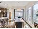 Bright dining area features hardwood floors, modern lighting, and large windows at 1558 White Violet Way, Louisville, CO 80027