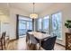 Bright dining room with hardwood floors, contemporary lighting, and large windows offering a pleasant view at 1558 White Violet Way, Louisville, CO 80027