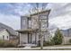 Contemporary home with modern architectural details and a welcoming front porch and neutral toned exterior at 1558 White Violet Way, Louisville, CO 80027