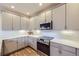 Charming kitchen with stainless steel oven and stylish gray cabinetry at 1558 White Violet Way, Louisville, CO 80027