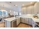 Open concept kitchen with stainless steel appliances and hardwood floors at 1558 White Violet Way, Louisville, CO 80027