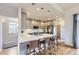 Modern kitchen with stainless steel appliances, a breakfast bar, and stylish pendant lighting creating an open space at 1558 White Violet Way, Louisville, CO 80027