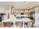 Modern kitchen featuring stainless steel appliances, a large island, and pendant lighting at 1558 White Violet Way, Louisville, CO 80027