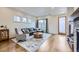 Stylish living room featuring hardwood floors, modern furniture, and ample natural light from multiple windows at 1558 White Violet Way, Louisville, CO 80027