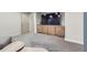 Spacious finished basement featuring a large TV and contemporary wooden cabinet with light grey carpet at 1558 White Violet Way, Louisville, CO 80027