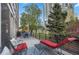 Relaxing balcony with seating, lounge chair, and views of the lush community green space at 1620 Little Raven St # 103, Denver, CO 80202