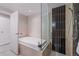 Modern bathroom showcasing a soaking tub with glass enclosure and shower with black tile accent wall at 1620 Little Raven St # 103, Denver, CO 80202