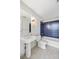 Bathroom featuring a pedestal sink and tub with blue subway tile, a sleek and modern design at 1620 Little Raven St # 103, Denver, CO 80202