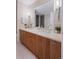 Bathroom featuring double sinks with modern fixtures, ample counter space, and modern lighting at 1620 Little Raven St # 103, Denver, CO 80202