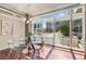 Bright dining area featuring hardwood floors, modern chandelier, and expansive windows overlooking the city at 1620 Little Raven St # 103, Denver, CO 80202