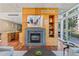 Living room featuring a contemporary fireplace, modern decor, hardwood flooring, and balcony access at 1620 Little Raven St # 103, Denver, CO 80202